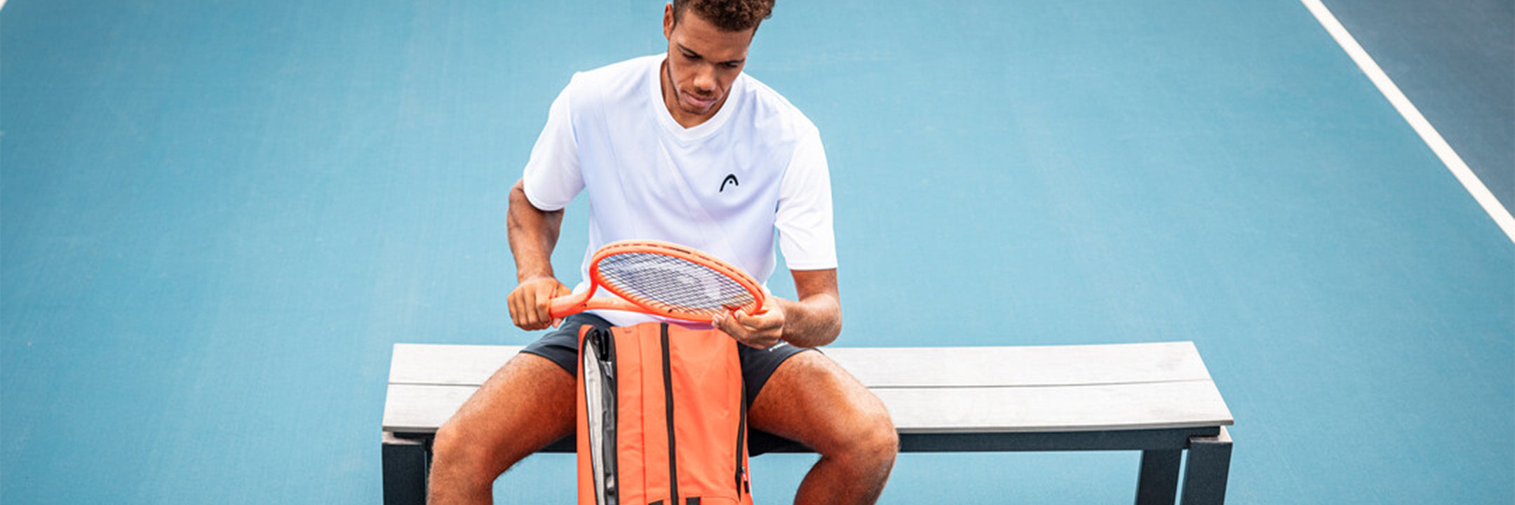 Tennis player using a HEAD Radical 2025 racquet and bag