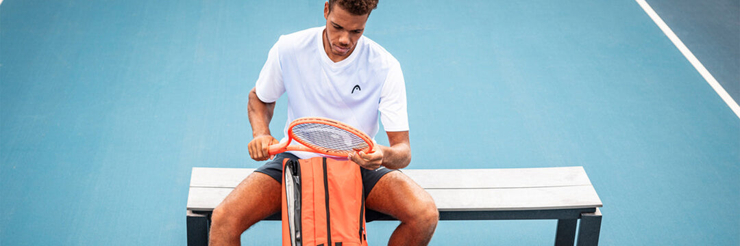 Tennis player using a HEAD Radical 2025 racquet and bag